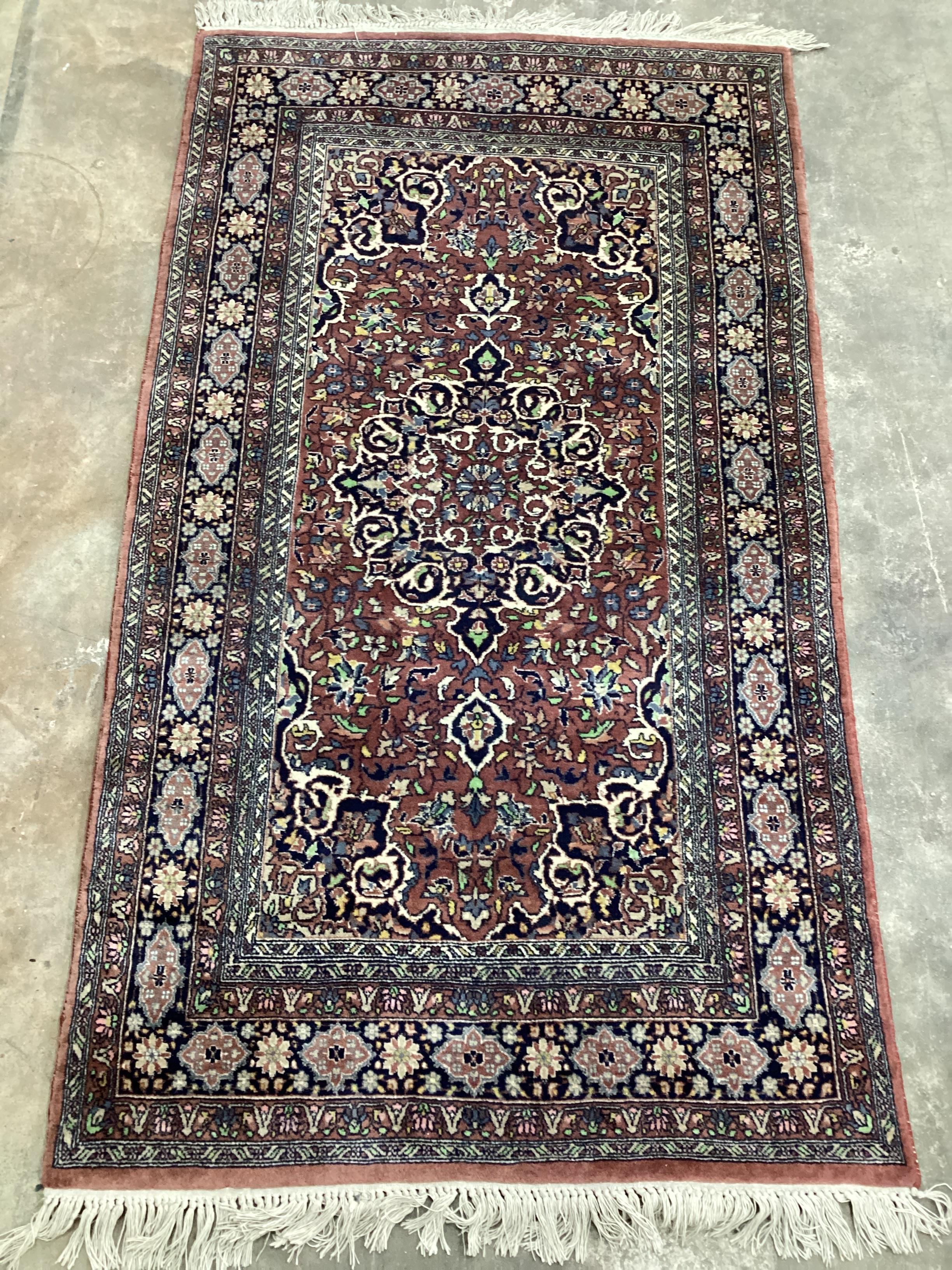 A North West Persian mauve ground multi-bordered rug, 165 x 94cm